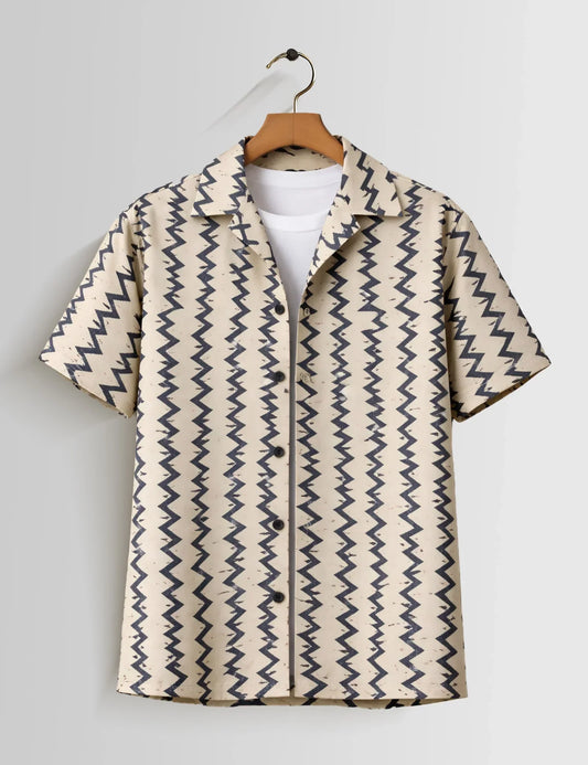 Beige shirt with blue zigzag pattern on a hanger against a white background