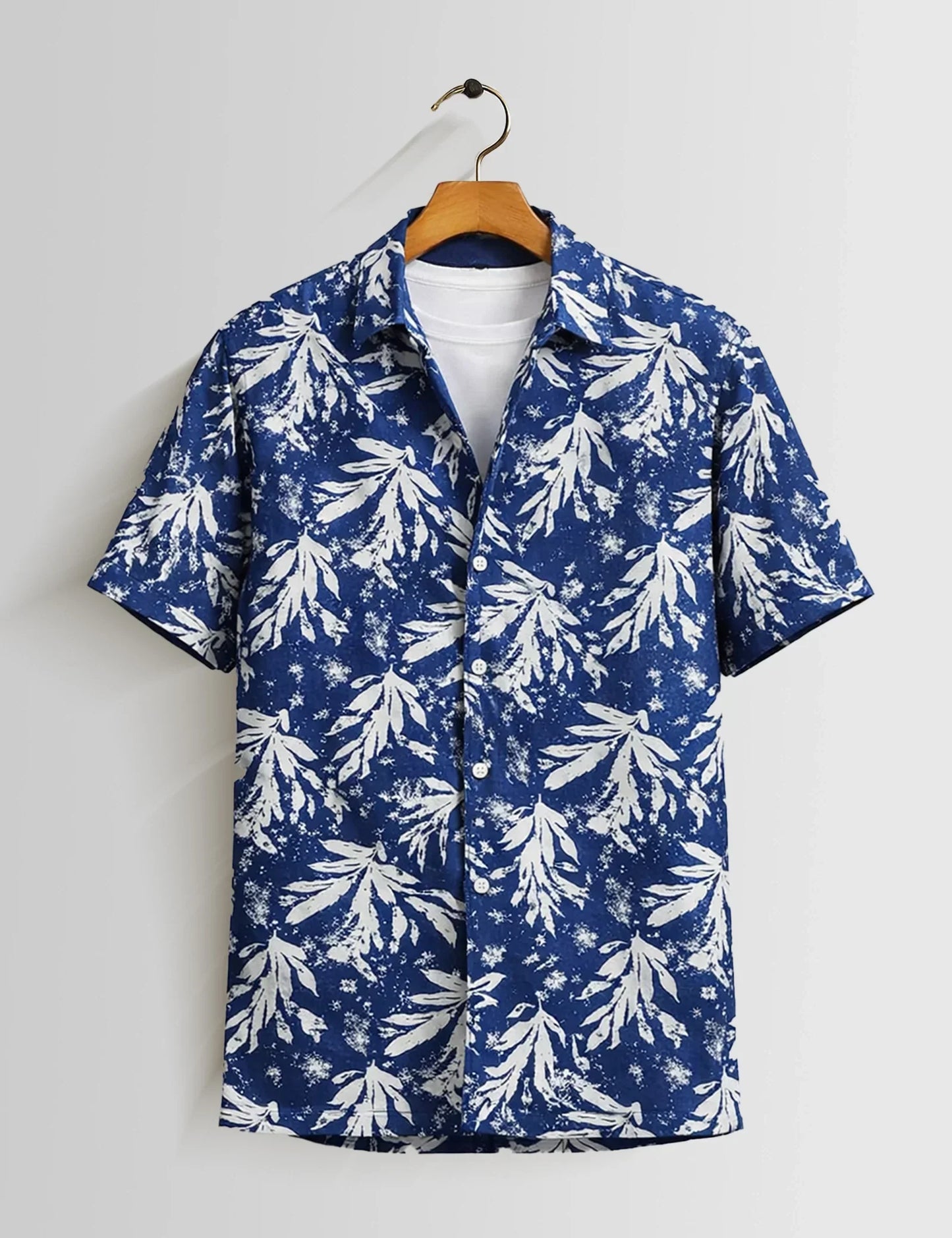 Blue and white floral patterned shirt on a hanger against a white background