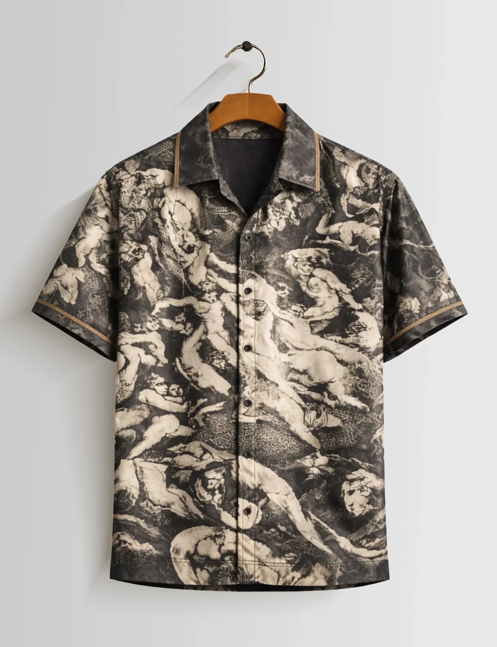 Short-sleeve shirt with a unique pattern on a hanger against a light gray background